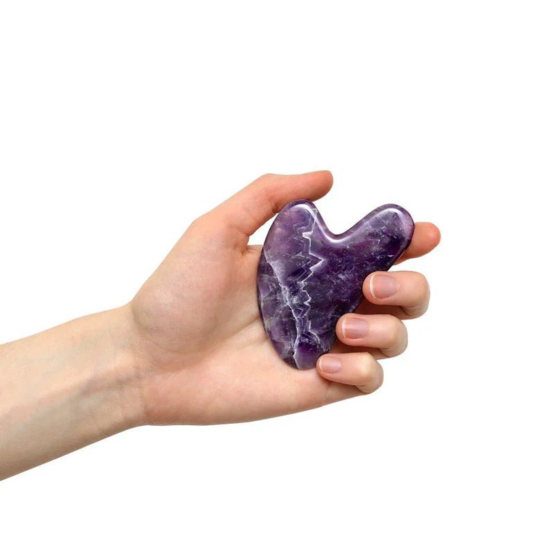 gua-sha-améthyste-main